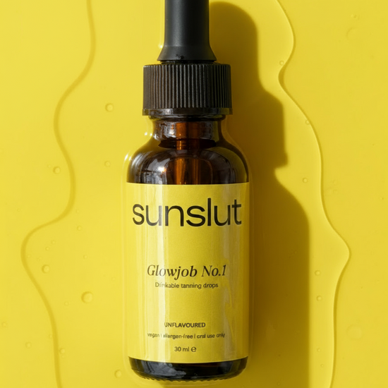 Sunslut Glowjob No.1 drinkable tanning drops in a brown glass bottle with yellow label on a yellow background.