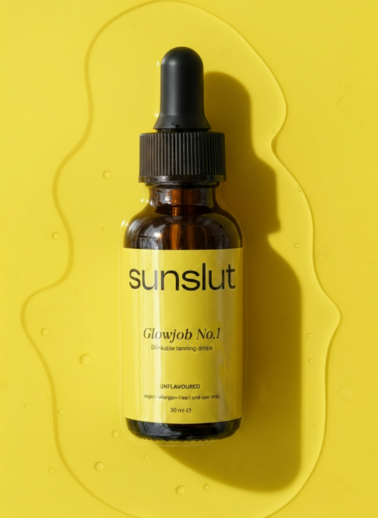Sunslut Glowjob No.1 drinkable tanning drops in a brown glass bottle with yellow label on a yellow background.