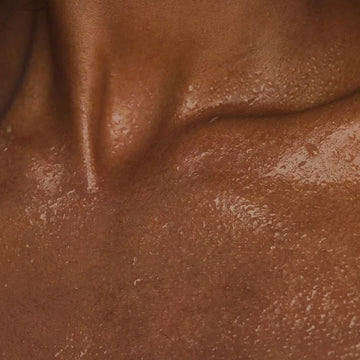 Macro shot of bronzed skin with luminous, hydrated texture — Sunslut-inspired radiant glow.